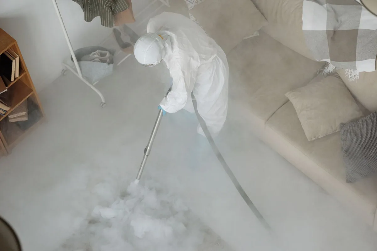 Biohazard cleanup technician in protective equipment, Cuero, TX